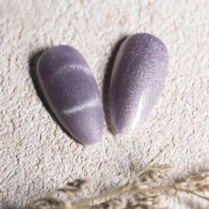 Light lavender and lilac cat eye gel polish with subtle metallic shimmer