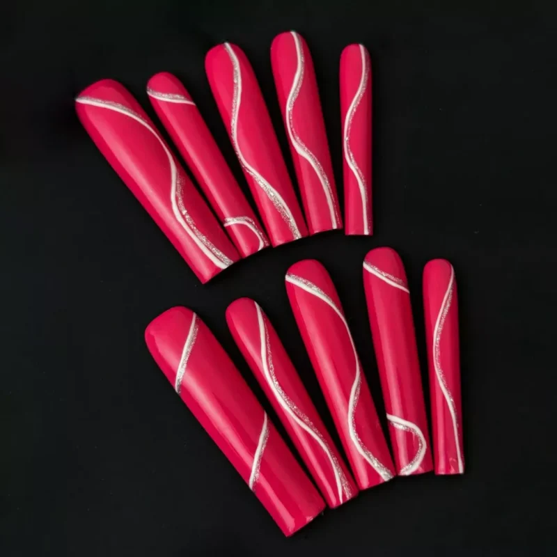 Long coffin magenta press-on nails with glossy finish and silver wave accents – front view