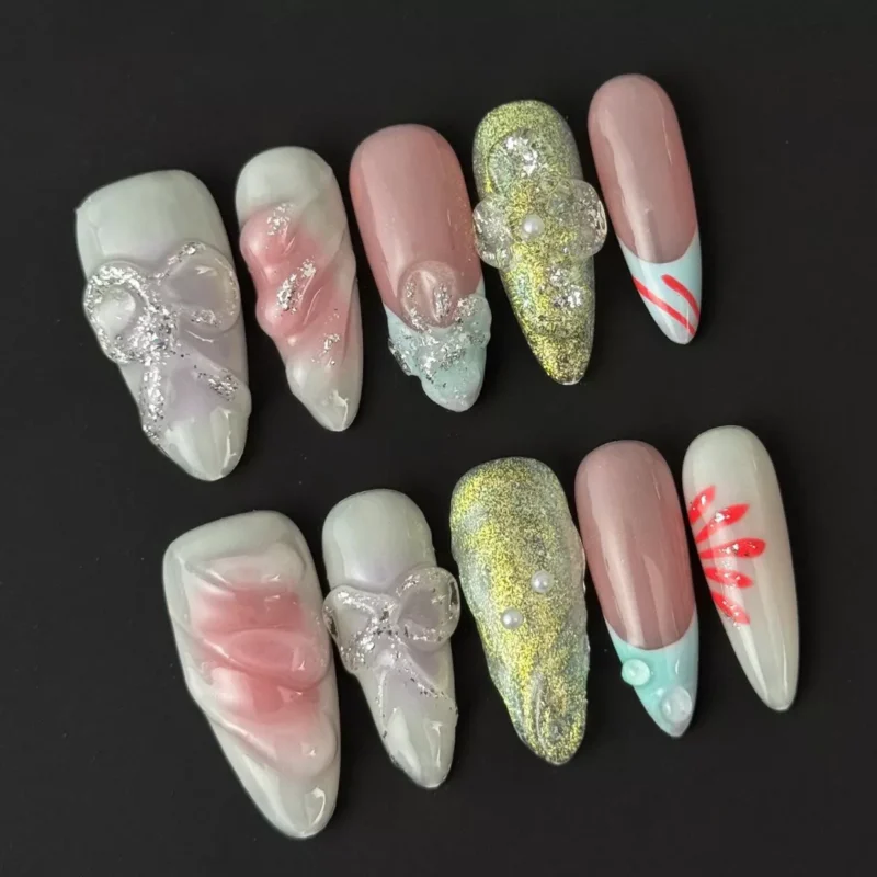 Mixed texture press-on nails featuring pink iridescent glitter and pearl-like accents