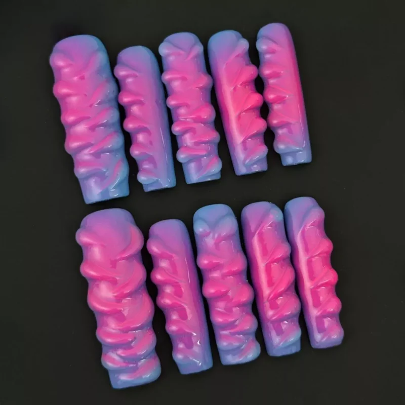 Glossy square-shaped press-on nails in neon pink and blue hues with textured ripple finish