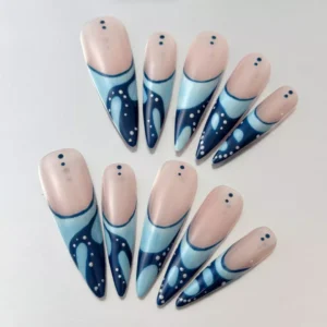 Side view of nude and blue stiletto press-on nails with minimalist dot design