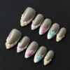 Nude Mixed Ocean Press-On Nails - 3D Shell Texture & Starfish Charms 6 Nude mixed ocean press-on nails with 3D shell texture and pearl details – full set view