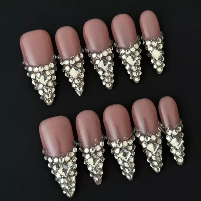 Side view of nude V-tip press-on nails with 3D rhinestone embellishments