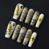Ombre snake press-on nails with yellow graffiti and bold symbol detail – full set display