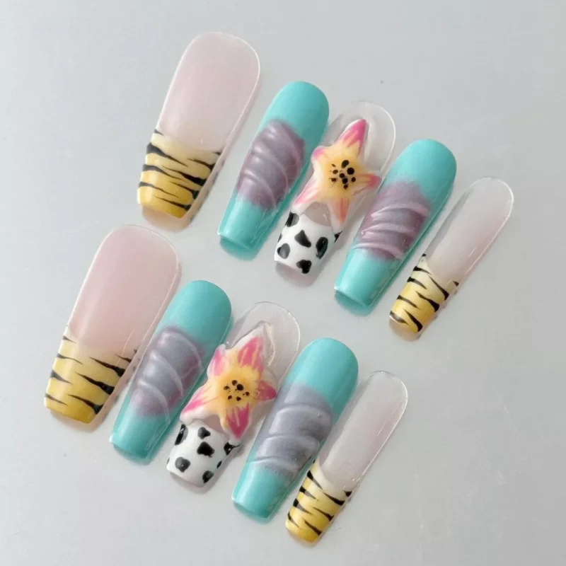 Side angle of pastel safari press-on nails with yellow and aqua accents
