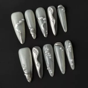Long almond silver chrome nails with 3D pearl drops and wavy texture – top layout