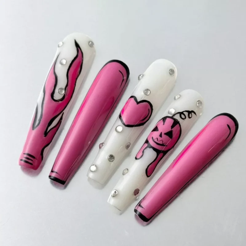 Side view of long stiletto Halloween nails with pink flames and glossy pumpkin charm