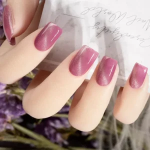 Pink magnetic gel polish cat eye nails on hand model