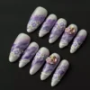 Purple marble press-on nails with 3D gem clusters and beaded accents – top view