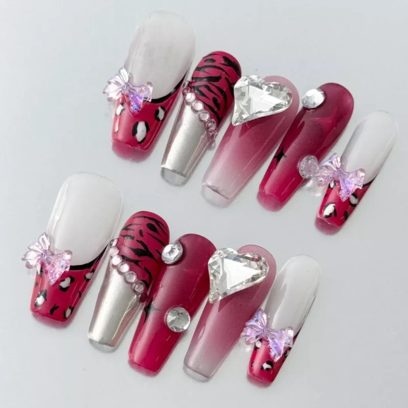 Glossy stiletto press-on nails in red gradient chrome with leopard art
