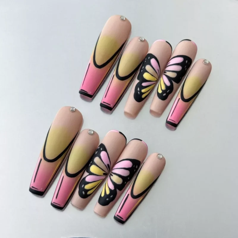 Close-up of matte pastel butterfly on gradient nail with crystal details