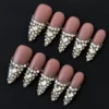Rhinestone encrusted V-tip press-on nails with full rhinestone encrusted edges – front view