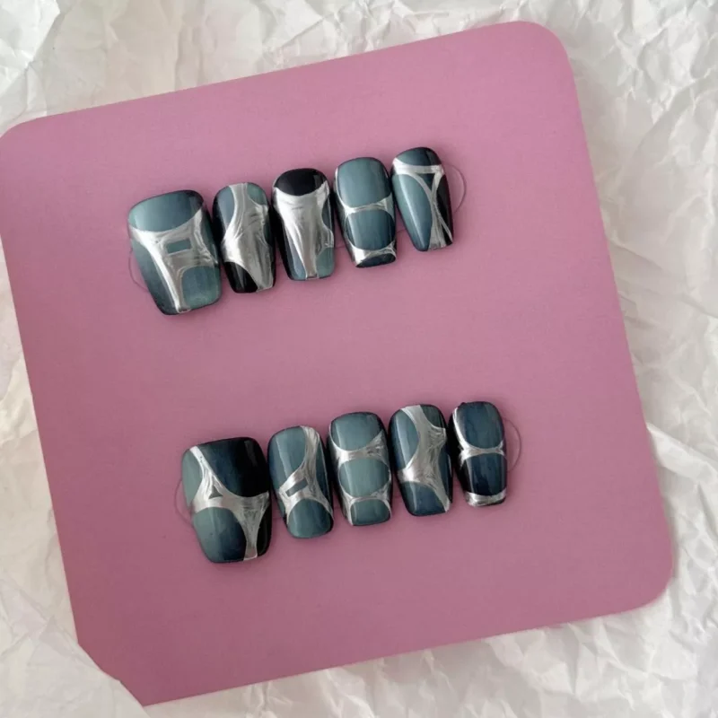 Square-shaped chrome nails in metallic blue-gray with sculpted surface – top view