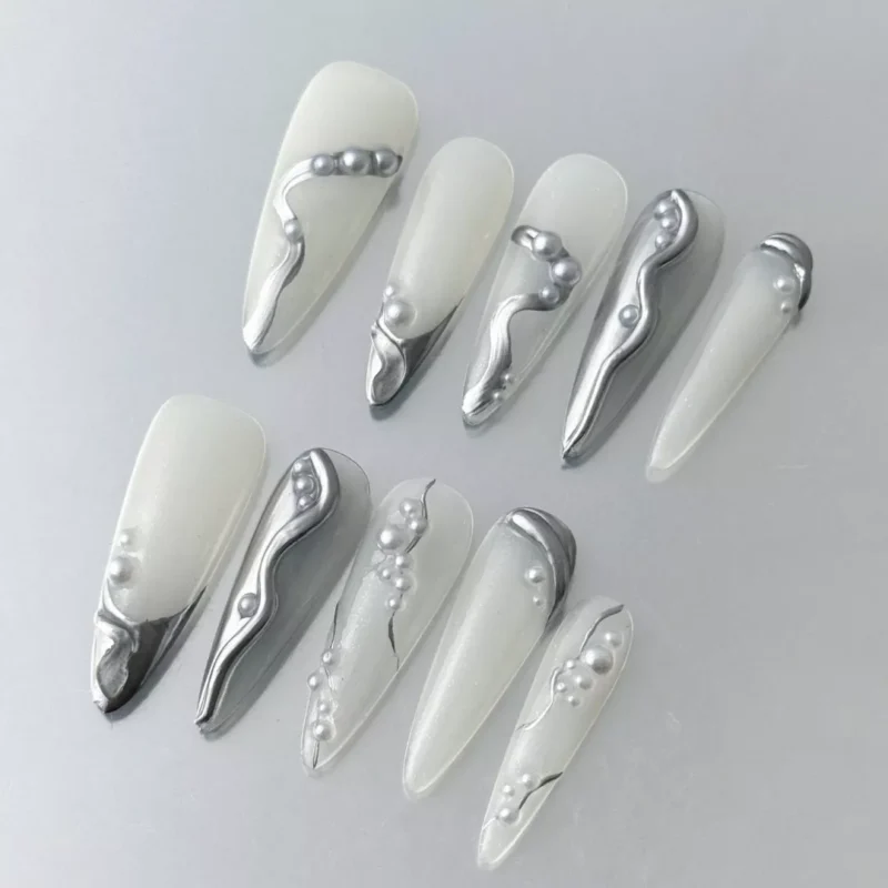 3D sculpted silver nails with chrome shine and abstract pearl detailing – side angle