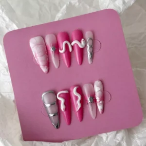 Pink marble press-on nails with metallic star and snake accents – angled view