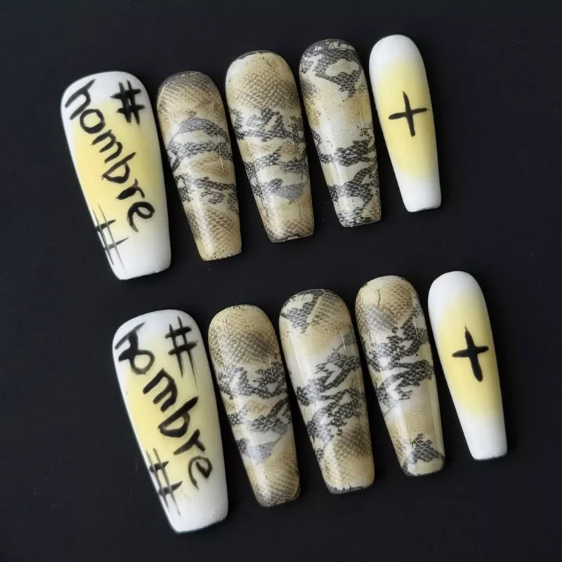 Side angle showing stiletto nail shape and chrome-accented graffiti design