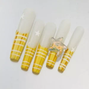 Sheer base press-on nails with yellow striped French tips and metallic ocean accents