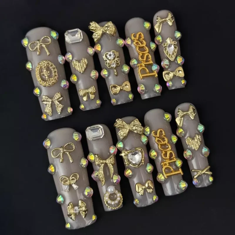Side angle of nude press-on nails featuring rhinestone trails and spiritual icons