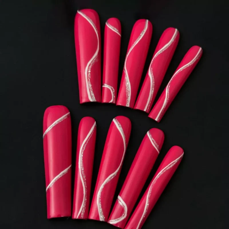 Close-up of silver wave design on long glossy magenta press-on nails – texture detail