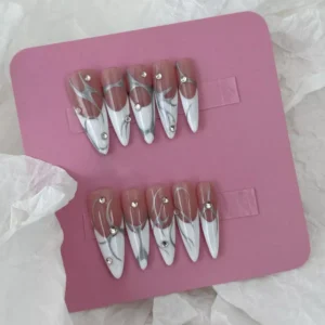 Full set display of abstract silver line press-on nails in long stiletto shape with rhinestone and white French tips