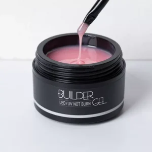 Brush dipping into UV Builder Gel with smooth pink viscosity.