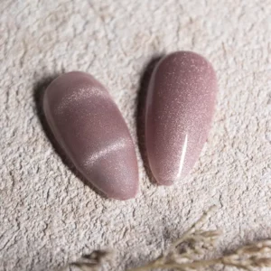 Nude mauve cat eye gel polish pair with fine shimmer on matte background