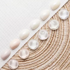 Pastel cream gel polish swatched on nail tips in soft peach, lilac, and mint tones