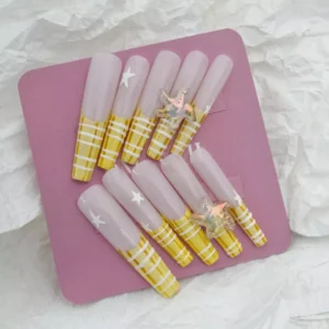 Summer ocean accent nails with clear sheer base and bright striped yellow tips