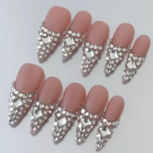 Rhinestone encrusted nude pink press-on nails with elegant French V-shape design