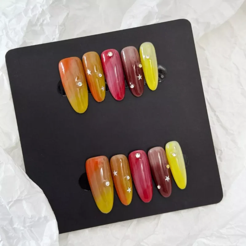 Warm color nail art set with multicolor glossy finish and glitter rhinestone features