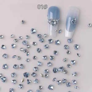 Blue heart and round nail rhinestones used in layered nail art with number tag