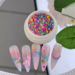 Close-up of colorful nail beads and completed nail art featuring 3D floral accents