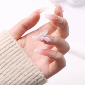 Profile angle of butterfly nail art with pink and clear gradients