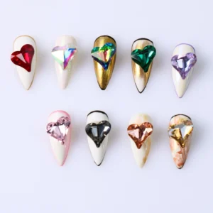 Assorted heart-shaped nail charms applied on artificial nails in various colors