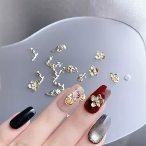 Close-up of nail charms and manicured nails featuring Golden Rose Nail Charms
