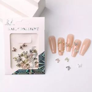 Assorted alloy butterfly nail charms in gold, silver, and rose gold displayed with nude press-on nails