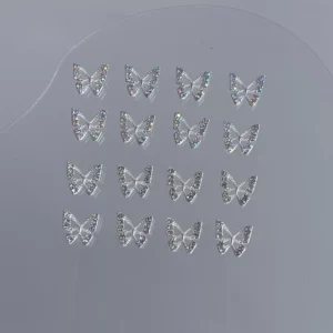 16 zircon butterfly nail charms arranged in rows on clear backing