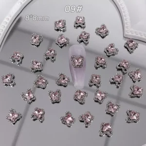 Butterfly-shaped alloy crystal nail charm with rhinestone border on glossy tip