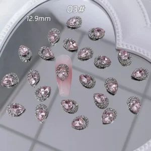 Teardrop-shaped pink crystal nail decoration with halo setting, 12.9mm