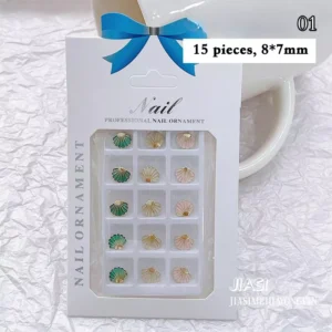 Mixed pastel and emerald alloy seashell nail charms in 3 colors on white tray