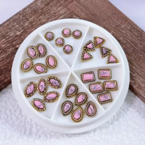 Soft pink and rose gemstone nail accents in gold antique settings