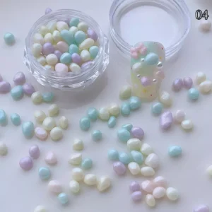 Pastel green and purple dopamine pebble charms scattered with box