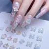 Aurora blossom nail charms in translucent pastel hues on floral manicure