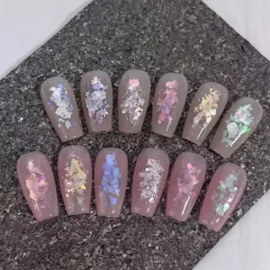 Full set of Aurora nail flake swatches over nude base in 12 shades