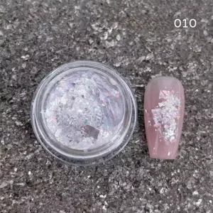 Silver-white nail glitter with translucent holographic shards and soft reflection