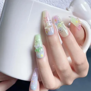 Pastel letter and starfish resin nail charms on pastel gradient nails