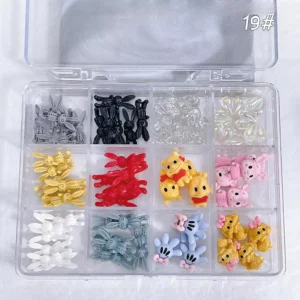 Balloon Bunny & Crystal Nail Charms arranged in a grid display case with assorted colorful resin pieces