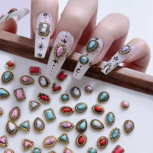 Manicured hand with baroque turquoise nail charms and assorted gemstone accents