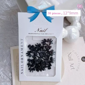 Jet black resin bow nail decorations in structured clear packaging