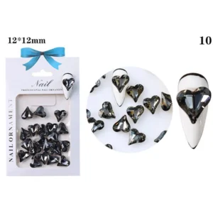 Smoky black faceted heart crystal on white nail